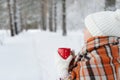 Winter female hand holding a red Cup. Royalty Free Stock Photo