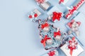 Winter festive background for advertising and design - set of blue, red and silver metallic gift boxes with ribbons on soft light. Royalty Free Stock Photo