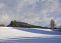 Winter field and forest countryside snow covered landscape with trees, hill and wooden high seat in luzicke hory