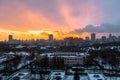 Winter fiery dawn over the city. Panoramic view of a modern residential area and a delightful sky in the background.