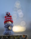 Winter figurine in front of Christmas tree lights Royalty Free Stock Photo