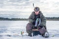 Winter fishing Fisherman enjoying a day on the ice Royalty Free Stock Photo