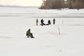 Winter fishing. Fishermen on a frozen river or lake Royalty Free Stock Photo