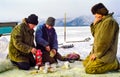 Winter fishing on the ice of Baikal. Fishermen are engaged in wi Royalty Free Stock Photo