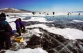 Winter fishing on the ice of Baikal. Fishermen are engaged in wi Royalty Free Stock Photo