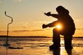 Winter fishing on ice. fisherman or angler hooking the fish Royalty Free Stock Photo