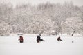 Winter fishing from the ice on the lake reservoir on a cold day