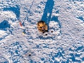 Winter fishing on ice, top aerial view, fisherman rod in hole in lake