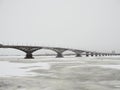 Winter fishing on the ice. The Volga river in Saratov, Russia. Road bridge on the horizon