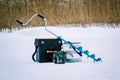 Winter fishing on the lake and fishermen on the ice in the background. Royalty Free Stock Photo