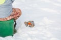 Winter fishing. A tool for winter fishing in hands. A fishing rod in the hands for freezing. Royalty Free Stock Photo