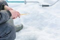 Winter fishing. A tool for winter fishing in hands. A fishing rod in the hands for freezing. Royalty Free Stock Photo