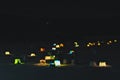 Winter fishing, tourist campground for fishermen at night, illuminous tents on the ice of a frozen winter lake. Urals, Rassia