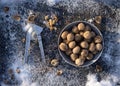 Winter flat lay with  walnut,   Nutcracker  on iron background Royalty Free Stock Photo