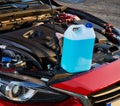 Winter fluid refilling in car. Winter service for safe driving.