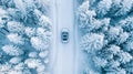 Winter forest aerial view car and truck driving on road in snowy landscape captured by drone Royalty Free Stock Photo