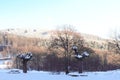 The winter forest is covered with fresh snow. The mountains and hills are completely white. Snow is falling, the sky is gray, Royalty Free Stock Photo