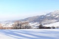 The winter forest is covered with fresh snow. The mountains and hills are completely white. Snow is falling, the sky is gray, Royalty Free Stock Photo