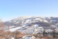 The winter forest is covered with fresh snow. The mountains and hills are completely white. Snow is falling, the sky is gray, Royalty Free Stock Photo