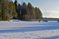 Winter forest lake with wooden bridge at sunset. Panoramic landscape and snowy trees Royalty Free Stock Photo