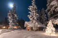 Outdoor winter and Christmas scene with wooden cabin in the woods.