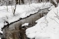 In the winter forest, the winter river runs. Royalty Free Stock Photo