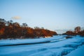 Winter forest on the river at sunset. Colorful landscape with snowy trees, Royalty Free Stock Photo