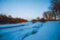 Winter forest on the river at sunset. Colorful landscape with snowy trees, Royalty Free Stock Photo
