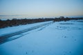 Winter forest on the river at sunset. Colorful landscape with snowy trees, Royalty Free Stock Photo