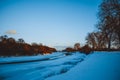 Winter forest on the river at sunset. Colorful landscape with snowy trees, Royalty Free Stock Photo