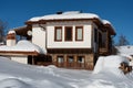 Winter forest scene. Small house at the mountain in a sunny winter day. Snowy fairytale in Bulgaria. Royalty Free Stock Photo