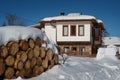 Winter forest scene. Small house at the mountain in a sunny winter day. Snowy fairytale in Bulgaria. Royalty Free Stock Photo