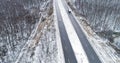 Winter forest track aerial snowy road driveway