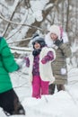 Winter forest. Two little girls playing snowballs with a friend Royalty Free Stock Photo