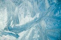 Winter frosty patterns on glass. Christmas festive background. Shiny ice crystals on window.