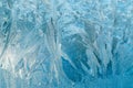 Winter frosty patterns on glass. Christmas festive background. Shiny ice crystals on window. Royalty Free Stock Photo