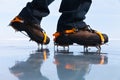 A tourist uses crampons on boots to hike on the ice of the frozen Baikal Lake Royalty Free Stock Photo