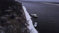 Winter frozen river. Clip.Cargo boats and bare trees on the shore taken from a bird's-eye view Royalty Free Stock Photo