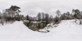 Winter full spherical hdri panorama 360 degrees angle view near narrow fast river in snowy pinery forest with gray pale sky in Royalty Free Stock Photo