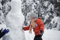 Winter fun. the boy sculpts the snowman.