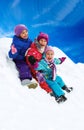 Winter fun, happy children sledding at winter time Royalty Free Stock Photo