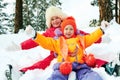 Winter fun, snow, happy children sledding at winter time Royalty Free Stock Photo