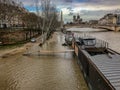 Long gangplank stretches from houseboat nearly to the shore of the flooded Seine River in Paris, France Royalty Free Stock Photo