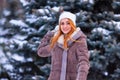 Winter ginger redhead girl throwing snowball at camera smiling happy having fun outdoors on snowing winter day playing in snow Royalty Free Stock Photo