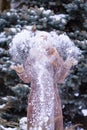 Winter ginger redhead girl throwing snowball at camera smiling happy having fun outdoors on snowing winter day playing in snow Royalty Free Stock Photo