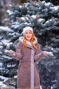 Winter ginger redhead girl throwing snowball at camera smiling happy having fun outdoors on snowing winter day playing in snow Royalty Free Stock Photo