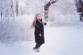 Winter girl blowing snow. Beauty Joyful Teenage Model Girl having fun in winter park. Beautiful girl laughing outdoors. Enjoying n Royalty Free Stock Photo