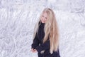 Winter girl blowing snow. Beauty Joyful Teenage Model Girl having fun in winter park. Beautiful girl laughing outdoors. Enjoying n Royalty Free Stock Photo