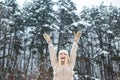 Winter girl. Happy woman. Winter forest happy mood. Happy girl raised her hands up. Christmas time. Royalty Free Stock Photo