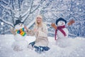 Winter girl. Happy young woman playing with a snowman on a snowy winter walk. Winter emotion. Young woman winter